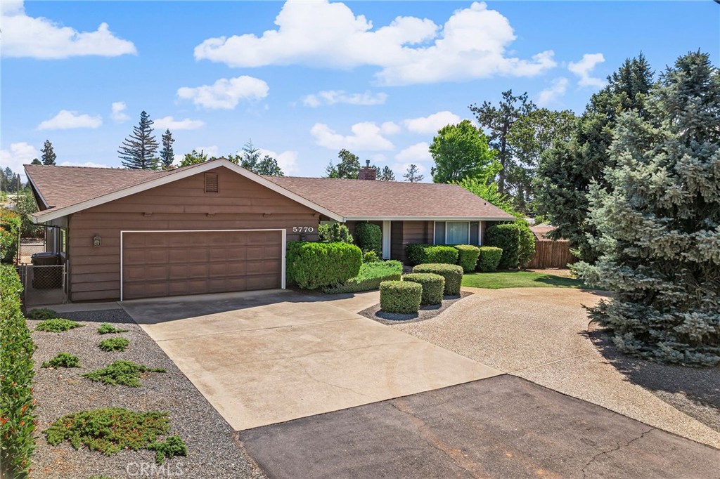 BEAUTIFUL MATURE LANDSCAPING AND CLASSIC RANCH STYLE HOME!! Welcome to this charming home where comfort meets convenience. A spacious covered back porch sets the tone—perfect for BBQs, relaxing evenings, or entertaining year-round. The fully fenced backyard is lush and green with easy-care landscaping, two open patio areas, citrus trees, an extra storage shed, and a drive-thru side gate for easy access. Inside, a tile entry flows into the inviting living room, featuring a large front window that frames the beautiful front yard trees and a timeless brick hearth with a cozy gas fireplace. The classic floor plan leads seamlessly to the dining area with sliding glass doors to the covered patio, and a beautifully remodeled kitchen boasting granite transformation countertops, crisp white cabinetry, updated appliances, abundant pantry space, and a convenient laundry closet with extra shelving. The primary suite is a private retreat with dual closets, a walk-in shower, and sliding glass doors opening to an open & sunny patio. The guest bedroom and hall bath are perfectly positioned across from each other for comfort and accessibility. This home also offers abundant storage, including a fully finished 2-car garage with a utility sink, workbench, pull-down ladder to attic storage, and a side yard access door. Outside, you’ll find a circle driveway, ample parking, including RV parking space and additional room to expand—ideal for a garden or personalized outdoor space. Located just 7.5 miles from Lime Saddle Marina on Lake Oroville’s north shore, you’ll enjoy quick access to world-class recreation—boating, skiing, fishing, boat-in camping, and rentals—all managed by California State Parks. This property blends charm, functionality, and lifestyle in one desirable package—don’t miss it!