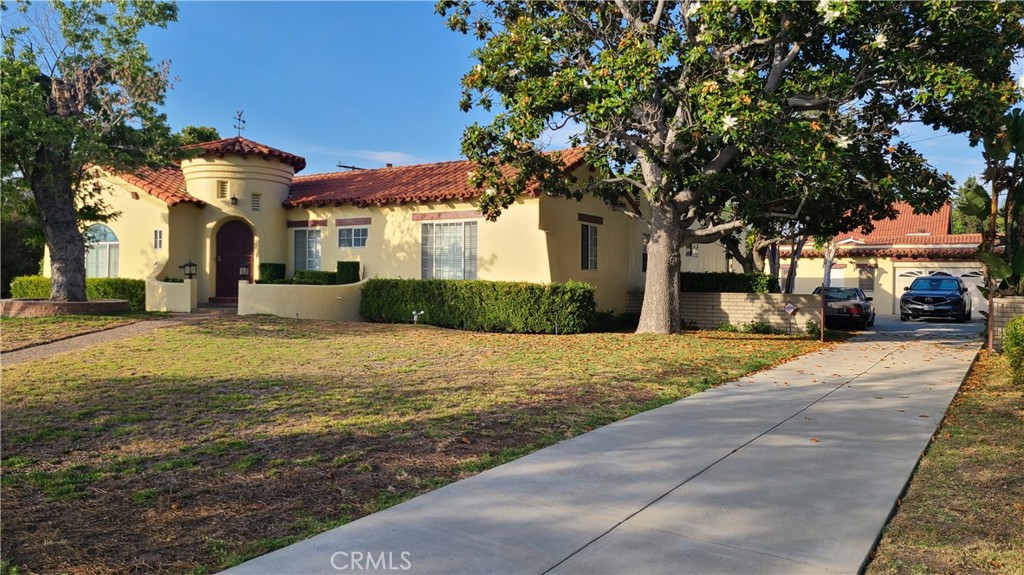 Charming Spanish style home sits on double lots with extra wide frontage... simply exquisite. Welcoming guests through the elegant foyer, into the open-floor plan Living Room with cathedral ceiling, fire place and wood-shuttered windows. Further going into the formal spacious Dining Room. The "North Wing" of the house includes the updated kitchen with center island and breakfast area, half bath, pantry and laundry area. The "South Wing" of the house includes 4 Bedrooms and 2 bathrooms updated with modern amenities. A rare find of style and comfort.