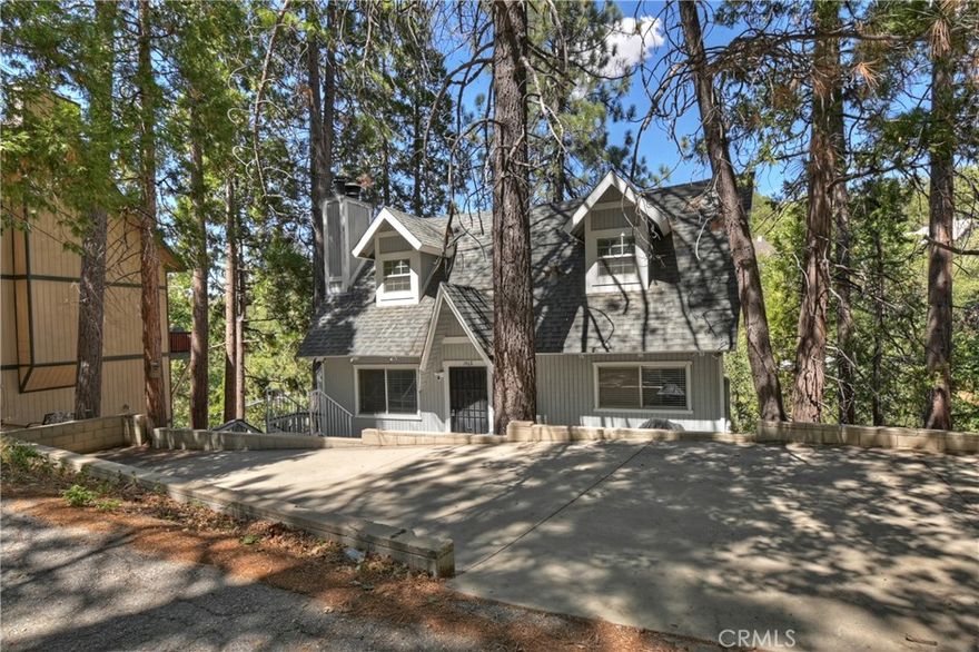 !!!Mountain Retreat with Lake Rights in Arrowhead Woods!!!

Discover the perfect mountain getaway in the coveted Arrowhead Woods community, complete with exclusive lake rights that provide access to pristine Lake Arrowhead. This thoughtfully updated home offers the ideal blend of rustic charm and modern convenience across three well-designed levels. The main level welcomes you with a warm and inviting living room anchored by a striking river rock fireplace, creating the perfect gathering space for family and friends. The open flow continues into the dining area and breakfast bar, making entertaining effortless. The updated kitchen features a convenient pantry for all your storage needs, while a comfortable bedroom and full bathroom complete this level. Step out onto the back deck to soak in the serene forested views that provide privacy and tranquility. Ascend to the top level where two generously sized bedrooms await, each featuring impressive high beamed ceilings that add architectural interest and a sense of spaciousness. A full bathroom serves this level, ensuring comfort and convenience for family and guests alike. The versatile bottom level expands your living space with a fantastic game room complete with its own rock fireplace, perfect for cozy evenings or entertaining. A fourth bedroom and three-quarter bathroom provide additional accommodation options, while the practical laundry room keeps household tasks organized. Another deck access from this level extends your outdoor living opportunities. Parking is never a concern with two separate parking areas that provide easy access and convenience for multiple vehicles and guests. The location couldn't be more desirable, situated close to Lake Arrowhead Elementary School for families with children. You'll enjoy short, scenic drives to Blue Jay Village, Lake Arrowhead Village, and Cedar Glen, putting shopping, dining, and recreational activities within easy reach. This exceptional property combines the best of mountain living with modern updates and unbeatable lake access, making it an ideal primary residence, vacation home, or investment property in one of the area's most sought-after communities.