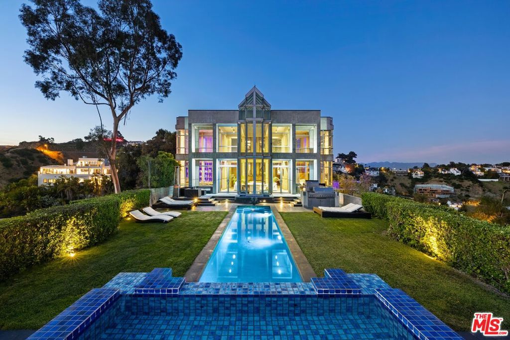 *** Skycastle has been reduced for a summer rental at $300,000 from June 1st-August 31st, 2025. Extended lease options available upon request.*** Welcome to Skycastle, a breathtaking architectural masterpiece designed by David Lawrence Gray, AIA, nestled in the Hollywood Hills. Previously enjoyed by celebrities, this stunning 12,000 sq ft home sits atop a privately gated half-acre promontory, offering 270-degree views from downtown to the Pacific Ocean. The elegant open floor plan features a spacious living area that flows into a gourmet kitchen designed by the Porsche Design Group, equipped with top-of-the-line stainless steel appliances (4 Miele Ovens, Miele Cook Top, Sub-Zero Fridge, Custom Southbend commercial 80,000 BTU broiler, and more). The property includes 7 bedrooms, with 6 private suites and a detached guest house. The lavish master suite boasts panoramic views, a private balcony, a palatial walk-in closet, a kitchenette with wet bar & Sub-Zero refridgrator-freezer, and a spa-like bathroom with a digital temperature controlled soaking tub and LED rainfall steam shower. Additional highlights include a large industry specked screening theatre room with full bar, fully equipped professional gym, 6 car motor court, and an infinity pool with a 12-person spa. Outdoor spaces feature a landscaped patio perfect for gatherings or tranquil evenings. Floor-to-ceiling windows and the 60' grand entry flood the space with natural light. Situated in a prestigious neighborhood, this exquisite property uniquely offers both unrivaled privacy and views, but with access to the vibrant lifestyle of Los Angeles. Additional A/V features: Crestron Home System, Concert quality main house audio system, large high-end flat screens throughout, Detached State-of-the-Art recording studio with panoramic views (available on request). Don't miss the opportunity to experience the very best of LA living in this extraordinary home!