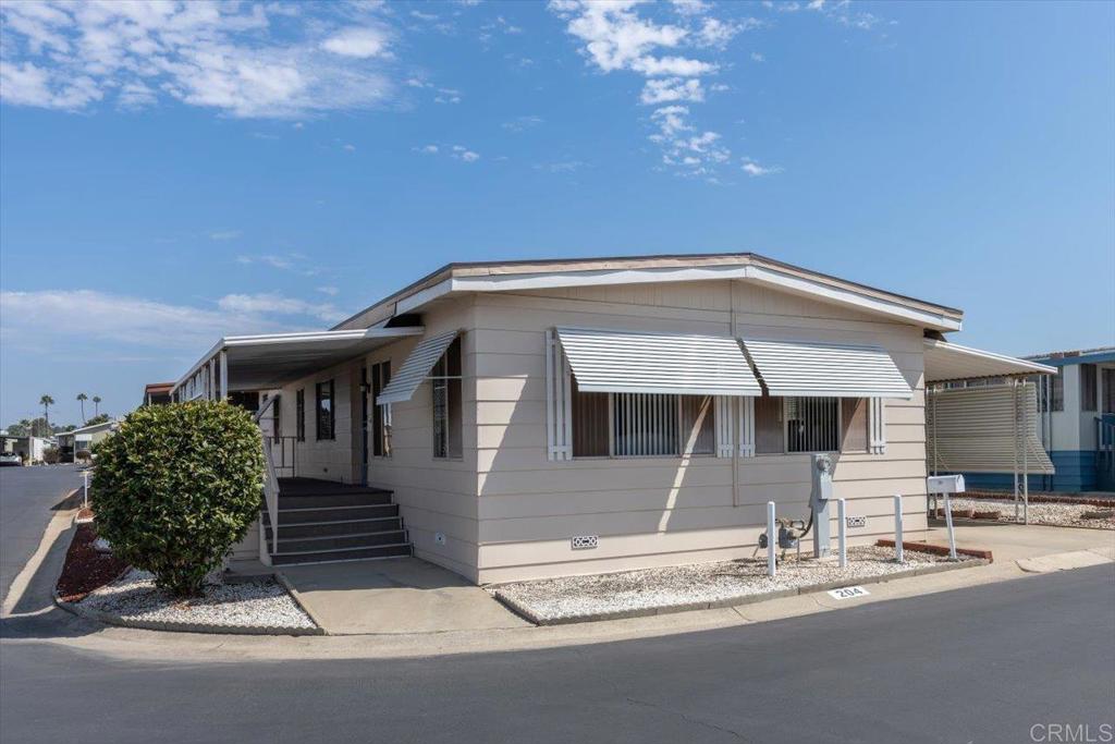 Fully Furnished home that shows pride of ownership located on a corner lot in a 55+ community! NO property taxes, as home is still on HCD registration. This open floor plan offers separate Living and Family rooms that can be shut off from one another with pocket doors or opened up to flow together. There are also multiple dining options including a built in breakfast nook and formal Dining room area. Lots of built in storage, including a built in desk conveniently located in the Kitchen, and a built in wet bar. The fireplace is purely decorative, as the homeowner opted to discontinue it in the recent re-roof. Newer roof, new dishwasher and toilet. The exterior boasts a low maintenance yard, private covered porch, and storage shed. Conveniently located just a short walk form the community pool and other amenities! Vista Royal Lodge is a 55+ park that allows second resident to be age 45+. 2 small pets okay with management approval. Monthly space rent is $1,056.20. Walking distance to Sprouts, Albertsons, Rite Aid, dining & shopping, near Downtown Vista; breweries, movie theater, transportation, Moonlight Amphitheater & a short drive to beaches!
