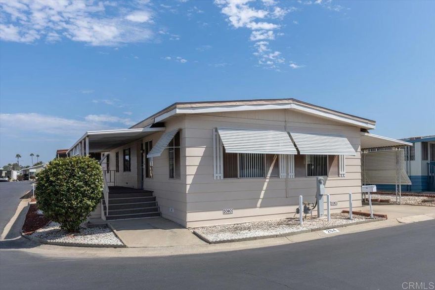 Fully Furnished home that shows pride of ownership located on a corner lot in a 55+ community!  NO property taxes, as home is still on HCD registration.  This open floor plan offers separate Living and Family rooms that can be shut off from one another with pocket doors or opened up to flow together.  There are also multiple dining options including a built in breakfast nook and formal Dining room area.  Lots of built in storage, including a built in desk conveniently located in the Kitchen, and a built in wet bar.  The fireplace is purely decorative, as the homeowner opted to discontinue it in the recent re-roof.  Newer roof, new dishwasher and toilet.  The exterior boasts a low maintenance yard, private covered porch, and storage shed.  Conveniently located just a short walk form the community pool and other amenities!  Vista Royal Lodge is a 55+ park that allows second resident to be age 45+.  2 small pets okay with management approval.  Monthly space rent is $1,056.20.  Walking distance to Sprouts, Albertsons, Rite Aid, dining & shopping, near Downtown Vista; breweries, movie theater, transportation, Moonlight Amphitheater & a short drive to beaches!