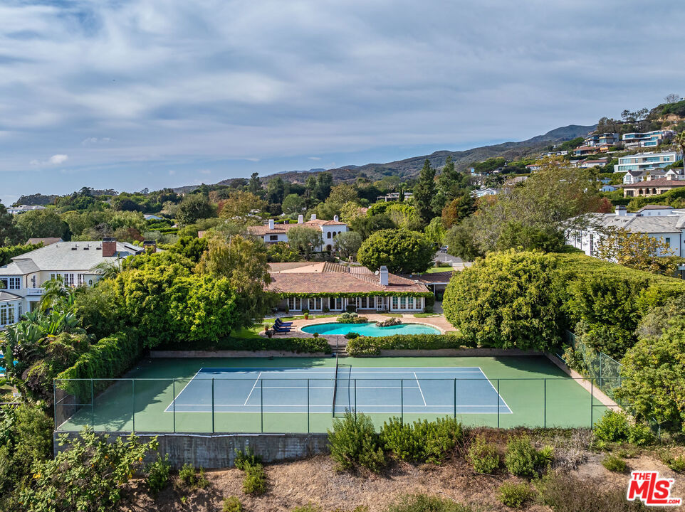 Rare 37,600 Square Feet Lot with full tennis court on prestigious San Remo rim. Offering spectacular views from the mountains to the city. Existing charming one-story traditional with sensational front porch, rolling lawns and white picket fence. Most prime section of San Remo - the best street in all Palisades Riviera - surrounded by major estates. A must see! Once in a generation.