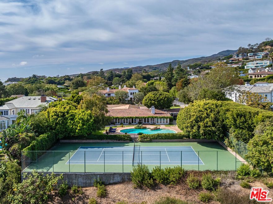 Rare 37,600 Square Feet Lot with full tennis court on prestigious San Remo rim. Offering spectacular views from the mountains to the city. Existing charming one-story traditional with sensational front porch, rolling lawns and white picket fence. Most prime section of San Remo - the best street in all Palisades Riviera - surrounded by major estates. A must see! Once in a generation.