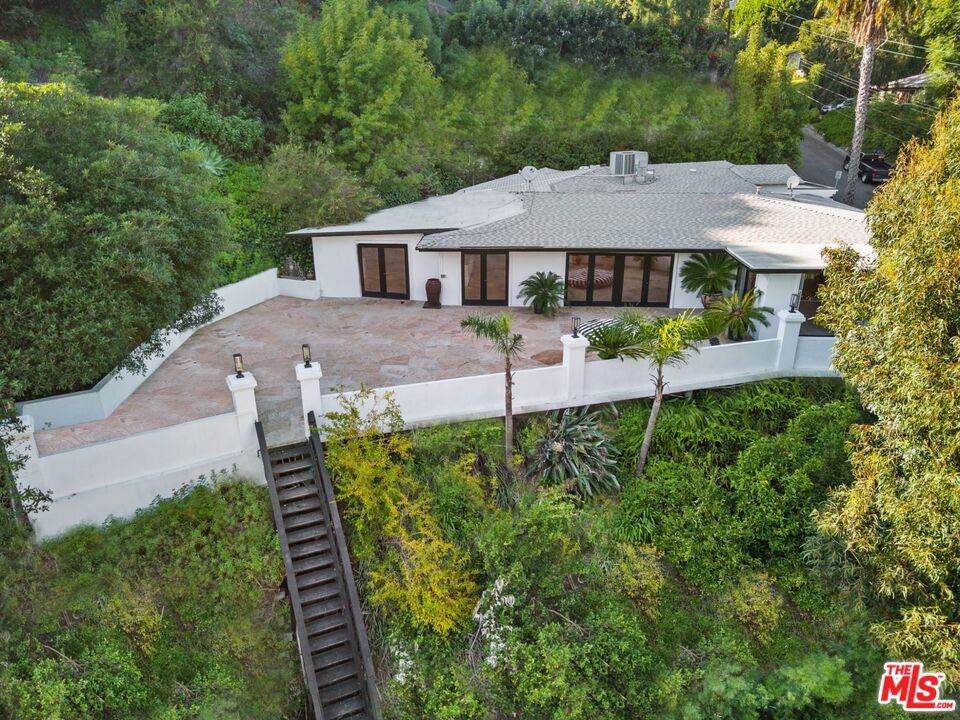 Nestled in the coveted Beverly Hills P.O. area, this updated Mediterranean home offers a single-story haven that seamlessly merges contemporary living with the enduring allure of its architectural heritage. Situated on a sprawling lot, the residence provides a perfect fusion of indoor and outdoor spaces, creating a harmonious retreat. As you cross the gated threshold, you're welcomed into a world of refined elegance. The large open-floor plan living and dining areas boast high ceilings, fostering an expansive atmosphere illuminated by the natural light streaming through large windows. The kitchen, adorned with modern appliances, is a culinary haven that seamlessly combines form and function. Step outside into your private oasisa vast outdoor space surrounding the property that offers not only ample room for relaxation but also a secluded haven for various outdoor activities. Picture entertaining guests in the lush garden or savoring quiet moments under the California sun. This 4-bedroom, 4-bath private retreat embodies security and seclusion, offering a unique sanctuary where luxury meets tranquility, and where the essence of Beverly Hills living unfolds in every corner.