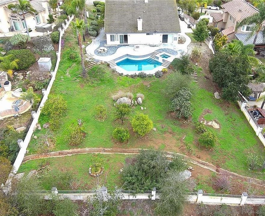 Experience elevated single-story living in this beautifully remodeled home located in desirable Southwest Escondido, just minutes from Lake Hodges and one of San Diego’s largest shopping destinations. Set on nearly a half-acre lot with breathtaking views from the kitchen and main living areas after master bedroom, this 4-bedroom, 2-bath residence blends comfort, privacy, and modern efficiency.  The open-concept floor plan features vaulted ceilings, luxury plank flooring, and abundant natural light. The gourmet kitchen is the heart of the home—designed to capture stunning views while offering quartz countertops, stainless steel appliances, a spacious center island, and custom cabinetry that flows seamlessly into the family room with a cozy fireplace.  The primary suite provides direct backyard access, a walk-in closet, and a spa-inspired bath with dual sinks, soaking tub, and separate shower. Three additional bedrooms offer flexibility for guests, a home office, or hobbies.  Outdoors, enjoy multiple patios, mature landscaping, and plenty of space for entertaining or future expansion. A 28-panel owned solar system, Tesla charger, RV parking, and a three-car garage add exceptional convenience. With NO HOA and close proximity to top-rated schools, shopping, dining, and outdoor recreation, this home offers style, sustainability, and panoramic Southern California living.