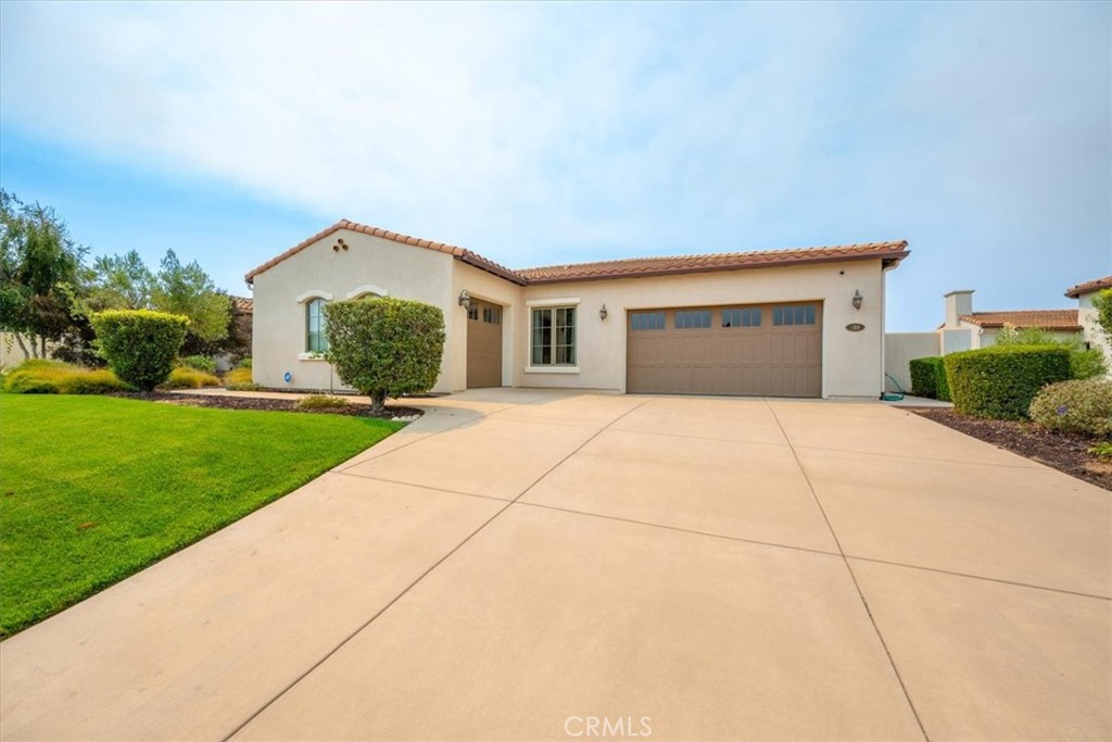 Discover this beautiful single-story home built in 2014, set in the serene Costa Pacifica Estates neighborhood. A grand circular foyer welcomes you into 2,426 sq ft of elegant living space with soaring 10' ceilings. The open-concept great room features a gas fireplace and flows seamlessly into the gourmet kitchen, complete with custom cabinetry, wood-framed windows, breakfast bar and stainless appliances. The luxurious primary suite offers two large walk-in closets, a spa-inspired bathroom with soaking tub, separate vanities, large shower, and private toilet room. A private door from the bedroom and another door from the living room lead to an intimate covered patio with its own gas fireplace—perfect for relaxing evenings. Two additional spacious bedrooms share a beautifully appointed hall bath. Premium finishes include imported Loewen solid wood 8' doors and windows, and abundant built-in cabinetry throughout. The backyard is designed for entertaining, with hardscaped patios, a gazebo with fountain, raised garden beds, an above-ground spa, and full fencing for privacy. Additional highlights include a 2-car garage plus separate 1-car garage, indoor laundry with sink, and easy access to Marian Hospital, Costco, Trader Joe’s, and more. Surrounded by green space and featuring a community park, this home offers the perfect balance of luxury and tranquility.