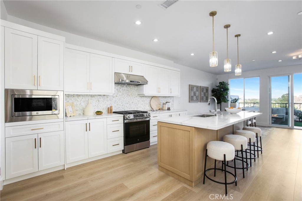 Exquisite Brand-New Contemporary Home in Laguna Niguel. Nestled at the end of a serene cul-de-sac, this corner-unit contemporary residence offers the perfect combination of modern design, luxury finishes, and smart-home technology. With 4 bedrooms, 4 bathrooms, and 2,165 sq. ft., this home is ideal for families, entertaining, and effortless Southern California living. Step inside to a bright, open-concept floor plan featuring soaring high ceilings and expansive windows that frame breathtaking city light views. Every detail has been thoughtfully designed — from the European cabinetry and white oak reeded interior doors to the custom wrought-iron staircase railing. The home's high-end finishes and designer touches create a harmonious blend of elegance and functionality. The gourmet kitchen is a centerpiece of the home, featuring European cabinetry, a wine captain, built-in appliances, and an open layout that flows seamlessly into the living and dining areas — perfect for hosting family and friends. This residence is fully prewired for home automation, including integrated surround sound, ceiling speakers, and ready-to-install TVs in every bedroom, making technology seamless and intuitive. Security and peace of mind are ensured with a Ring door camera and burglary alarm system, while a central vacuum system adds convenience to daily life. Each bathroom reflects modern luxury, with LED mirrors, sleek fixtures, and thoughtfully designed layouts. Closet organizers maximize storage while maintaining style and order. Outdoor living is equally impressive, featuring a built-in BBQ and gas firepit, perfect for entertaining or relaxing under the California sky. The expanded two-car garage and ample guest parking complete this property, ensuring both functionality and comfort. This home is more than just a residence — it is a masterpiece of contemporary design, offering modern technology, premium finishes, and a lifestyle of ease and sophistication. Rarely does a newly constructed smart home of this caliber become available in Laguna Niguel, making this an extraordinary opportunity for discerning buyers.