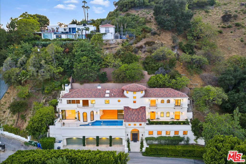 Set above the world-famous Sunset Strip, just across from the Chateau Marmont, this striking Italian-inspired villa is the perfect blend of timeless elegance and modern sophistication. Spanning two hillside parcels, this estate offers over 6,600 square feet of carefully designed living space with unobstructed city views from nearly every room. Privately positioned on a quiet cul-de-sac, the home welcomes you with a dramatic two-story entry, sweeping staircase, and elevator access to all levels. Twelve-foot ceilings and expansive Euroline doors and windows flood the interiors with light and frame panoramic vistas, seamlessly connecting indoor spaces to multiple terraces and a dazzling mosaic-tiled pool and spa.Inside, the estate is adorned with curated details: crystal chandeliers, hand-laid mosaics, custom lighting, and a refined mix of limestone and hardwood floors. The chef's kitchen is outfitted with premium Sub-Zero, Thermador, and Miele appliances, ideal for both casual meals and entertaining. The home features four spacious bedrooms and four and a half bathrooms, including an exceptional primary suite. This luxurious retreat offers 16-foot ceilings, Parquet floors, a fireplace, and a resort-style bath with steam shower, soaking tub, sauna, and dual walk-in closets. Two private terraces off the suite provide an incredible setting for both sunrise and sunset views. Additional highlights include a media room, an office with its own terrace, a tranquil garden with mature lemon trees, and a four-car garage. Every space has been thoughtfully reimagined for comfort, functionality, and visual impact. This is a rare opportunity to lease a fully realized view estate in one of Los Angeles' most prestigious enclaves, offering privacy, scale, and craftsmanship just minutes from the heart of the city.