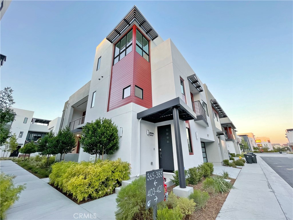 Welcome to this beautifully upgraded corner unit in the desirable Levity community at Tustin Legacy, offering 2,183 sq. ft. of light-filled living space and some of the best park and Hangar views in the area. This three-level home features a versatile 3-bedroom, 3-bathroom layout, including a first-floor bedroom with a full en-suite bath, perfect for guests, in-laws, or a private home office. The main level showcases a spacious open-concept great room and dining area, a covered balcony with sweeping views, and a chef-inspired kitchen equipped with quartz countertops, stainless steel smart appliances, a large center island with bar seating, and a walk-in pantry. The primary suite upstairs is a true retreat, with oversized windows that flood the room with natural light and capture stunning views of the park and surrounding landscape. The additional bedroom offers its own scenic outlooks. Enjoy relaxing or entertaining on the third-floor deck, ideal for soaking in sunset views. Additional highlights include a 2-car garage, high-end finishes throughout, and resort-style community amenities such as a pool, spa, BBQ area, and access to Victory Park. Just minutes from The District at Tustin, top-rated schools, shopping, dining, and more. Now available for lease, don’t miss this rare opportunity to live in one of Tustin’s most sought-after communities!