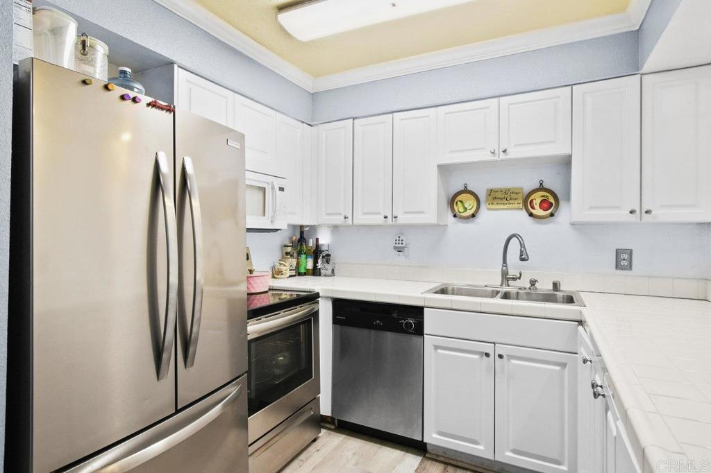 Don’t miss out on this GROUND LEVEL, 3-bedroom, 2-bathroom condo with in- unit Washer and Dryer—perfect for first-time buyers or investors! The primary suite includes an en-suite bathroom, while the private patio offers a great spot to unwind or enjoy meals outdoors. Stay cool year-round with A/C and enjoy the convenience of two dedicated parking spaces and plenty of open parking space right outside the unit on the street. The kitchen comes equipped with stainless steel appliances, making meal prep and entertaining easy. HOA fees cover water, a refreshing community pool, and a picnic area—giving you more value and less hassle. Ideally located near SDSU, this condo also offers quick access to Snapdragon Stadium, Fashion Valley Mall, golf courses, and San Diego’s beautiful beaches. With its prime location, desirable amenities, and functional layout, this home is a fantastic opportunity you don’t want to miss!