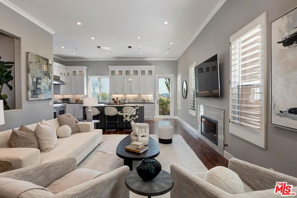 Nestled on a picturesque gated street across from the prestigious Summit Club, this beautifully updated Mediterranean residence blends classic charm with modern comfort all set against a stunning backdrop of serene mountain vistas. Thoughtfully designed and impeccably maintained, the home offers an open, sun-filled floor plan ideal for both relaxed everyday living and effortless entertaining. Upon entry, you're greeted by gleaming hardwood floors and an abundance of natural light that pours through large windows. The spacious living and dining areas flow seamlessly into a fully remodeled cook's kitchen, featuring granite countertops, premium appliances, and ample cabinetry. Step outside to a serene, grassy backyard and patio perfect for outdoor dining, lounging, or simply enjoying the spectacular sunset views. Upstairs, the primary suite serves as a private sanctuary, complete with a cozy fireplace, private balcony, and a spa-like ensuite bath. Three additional well-sized bedrooms and a convenient upstairs laundry room complete the second floor. Beyond the home itself, residents enjoy unparalleled access to a wide array of resort-style amenities included in the low monthly HOA dues. Combining location, lifestyle, and luxury, this property offers the perfect environment to call home.