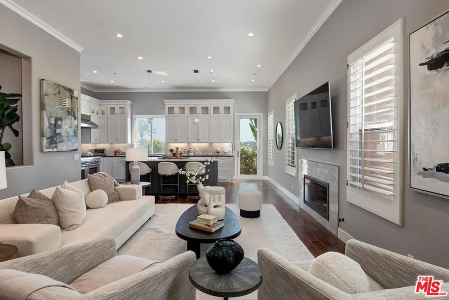 Nestled on a picturesque gated street across from the prestigious Summit Club, this fully remodeled Mediterranean residence blends classic charm with modern comfort all set against a stunning backdrop of serene mountain vistas and ocean views. Thoughtfully designed and impeccably maintained, the home offers an open, sun-filled floor plan ideal for both relaxed everyday living and effortless entertaining. Upon entry, you're greeted by gleaming hardwood floors and an abundance of natural light that pours through large windows. The spacious living and dining areas flow seamlessly into a fully remodeled cook's kitchen, featuring granite countertops, premium appliances, and ample cabinetry. Step outside to a serene, grassy backyard and patio perfect for outdoor dining, lounging, or simply enjoying the spectacular sunset views. Upstairs, the primary suite serves as a private sanctuary, complete with a cozy fireplace, private balcony, and a spa-like ensuite bath. Three additional well-sized bedrooms and a convenient upstairs laundry room complete the second floor. Beyond the home itself, residents enjoy unparalleled access to a wide array of resort-style amenities included in the low monthly HOA dues. Combining location, lifestyle, and luxury, this property offers the perfect environment to call home.