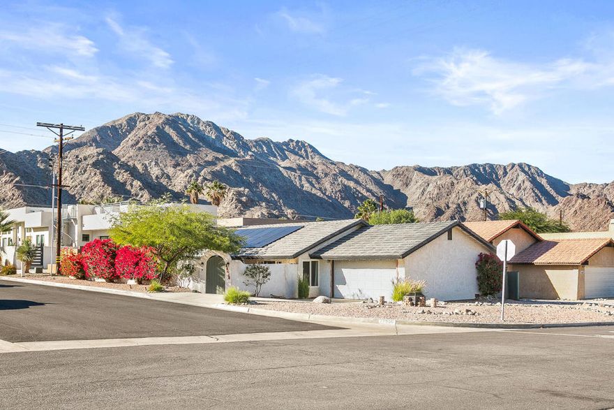 At the top of La Quinta Cove, your new home is waiting for you. With close-up mountain views, this home is perfect for outdoor enthusiasts. With four trailheads and Velasco Park in easy walking distance, families, hikers, cyclists, and runners have endless ways to explore and enjoy the outdoors. Looking for relaxed outdoor privacy or hosting friends and family, the Mediterranean-style courtyard and patio have you covered. Step through the front door onto your durable laminate flooring to find the most efficient Split floor plan, featuring 3 bedrooms and 2 bathrooms to the left and an open-concept living area to the right, all under your 1-year-old roof. Back into the 2-car garage to unload your groceries directly to your quartz kitchen countertops. Feel the cool air from your 6-month-old A/C system and don't feel guilty for using it with your 1-year-old solar system.  Enjoy the 2-year-old water softening system protecting you and your home. All appliances included.