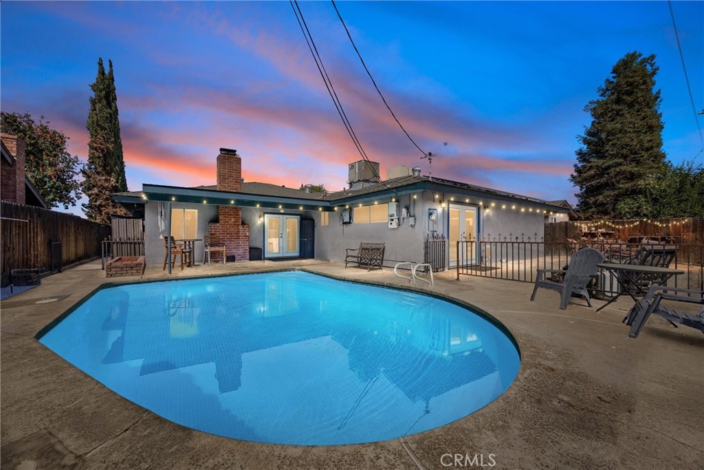 Beautifully updated SW home with a POOL is making its splash debut! This 5B/2B -1732 sqft home features two GORGEOUS remodeled bathrooms—one with a farmhouse-style double vanity and the other with a stunning walk-in shower with custom tile—both enhanced by granite countertops for a timeless, elevated finish. The kitchen shines with a new quartz counter and a new cooktop! French doors open to a newly painted covered patio and new patio roof perfect for relaxing or dining al fresco. Relax by the refreshing pool resurfaced in 2024, gather around the outdoor fireplace, and unwind beneath the string lights that set the perfect evening mood. Additional highlights include a tankless water heater, brand-new exterior paint, and freshly painted fascia, combining efficiency with standout curb appeal.