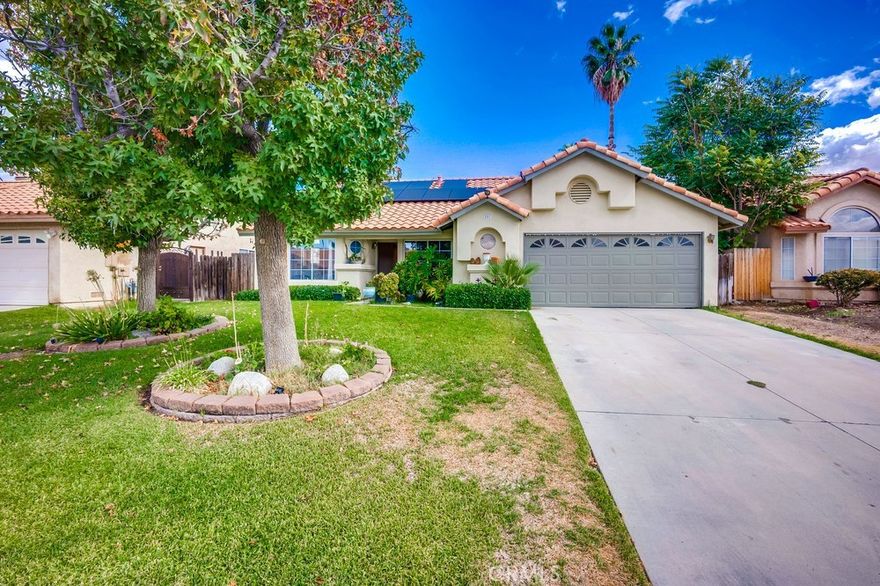 Welcome to this beautiful single story home, which has 3 bedrooms, 2 bathrooms and sits on a very large 10,454 square foot lot that offers space, flexibility, and future potential. The property features great curb appeal with a well-kept front lawn, light landscaping, and a terracotta-colored roof that adds warmth to its exterior. The driveway leads up to a two-car garage, with a walkway branching off toward the front entrance.
Inside, the kitchen overlooks the living and dining areas, creating a connected, functional space ideal for everyday living. The area features slanted ceilings, recessed lighting, and a ceiling fan, while sliding glass doors off the dining section provide direct access to the backyard and plenty of natural light.
A second living space, ideal as a formal sitting room or lounge, adds extra flexibility, while the hallway provides an open nook suitable for additional seating or decor. The home includes three bedrooms, including a spacious primary suite with direct access to the backyard.
The backyard itself is expansive, offering endless opportunities for outdoor entertaining, landscaping, or creating a private retreat. Leased solar panels provide an energy-efficient boost to the home. You'll want to make this your forever home.