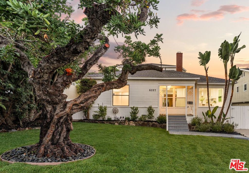 Welcome to 6027 W 76th Street - a beautifully reimagined four-bedroom, four-bath residence in Westchester's coveted North Westport Heights enclave. Thoughtfully blending timeless design with modern refinement, this home offers a graceful balance of comfort, sophistication, and effortless California indoor-outdoor living. Inside, an inviting formal living room anchored by a classic fireplace sets the tone for warmth and connection. Toward the rear, a spacious family room with custom built-ins opens seamlessly to the backyard - perfect for both entertaining and unwinding. The formal dining area overlooks the landscaped front garden, while the remodeled kitchen impresses with quartz countertops, white shaker cabinetry, stainless steel appliances, and generous storage - a space where style meets function. Outdoors, the property unfolds into a private retreat designed for relaxation and gathering. Three distinct terraces offer an array of experiences: a lower level with a sparkling pool and spa, a middle patio with a built-in barbecue for al fresco dining, and an upper terrace with sweeping city views, a lush lawn, and a charming gazebo. Upstairs, the expansive primary suite serves as a tranquil sanctuary with its own fireplace, city-light vistas, and a spa-inspired ensuite featuring a soaking tub and separate shower. A secondary ensuite bedroom on this level adds comfort and versatility, complete with an oversized bath featuring a soaking tub and separate shower. On the main level, two additional bedrooms include one with its own ensuite bath, while the other enjoys a guest bathroom in the hallway with a step-in shower. Additional highlights include a full-size laundry room with storage, a detached two-car garage, and a long driveway offering ample parking or potential for a future studio or pool house. Perfectly situated near Westchester's vibrant shops, restaurants, beaches, and the best of LA's Westside, 6027 W 76th Street embodies elevated Southern California living - where classic design, modern luxury, and location converge in effortless harmony.