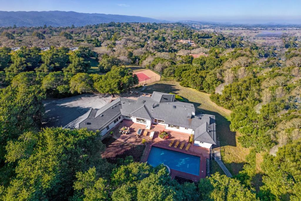 This rare offering truly has it all 2.5 acres in the prestigious Westridge area with complete privacy set back from the street, San Francisco and foothill views, a regulation-size tennis court, resort-style pool with elevated spa and waterfall, and a poolside sauna with an outdoor shower. The well-appointed classic ranch home features bright and light interiors with fine hardwood floors throughout its effortless single-level design. Recent updates, including crisp white paint, refinished floors, new lighting, and newer appliances, make this home move-in ready while also presenting an excellent opportunity to further transform it into your dream vision. Four spacious bedrooms, each with an en suite bath, include one that is privately located and perfect for guests or a home office. In a premier location, with 2.5-acre minimum parcels, and access to top-rated Portola Valley schools, this property offers an unparalleled lifestyle of sophistication, serenity, and endless potential.