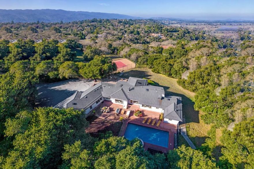 This rare offering truly has it all  2.5 acres in the prestigious Westridge area with complete privacy set back from the street, San Francisco and foothill views, a regulation-size tennis court, resort-style pool with elevated spa and waterfall, and a poolside sauna with an outdoor shower. The well-appointed classic ranch home features bright and light interiors with fine hardwood floors throughout its effortless single-level design. Recent updates, including crisp white paint, refinished floors, new lighting, and newer appliances, make this home move-in ready while also presenting an excellent opportunity to further transform it into your dream vision. Four spacious bedrooms, each with an en suite bath, include one that is privately located and perfect for guests or a home office. In a premier location, with 2.5-acre minimum parcels, and access to top-rated Portola Valley schools, this property offers an unparalleled lifestyle of sophistication, serenity, and endless potential.