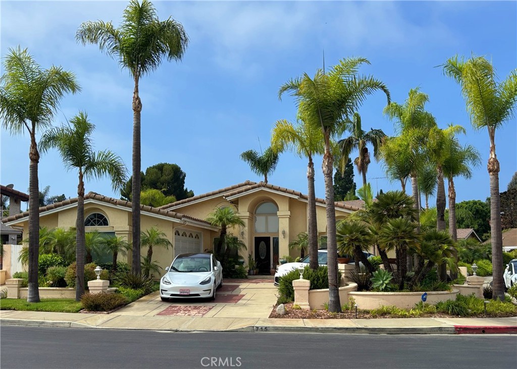 Cannot beat this location in the prestigious guard gated community of Bixby Hill in the beach community of Long Beach! One-Story Mediterranean home with circular drive on a large corner lot. Home features wood floors in the living room and bedrooms. Gourmet kitchen island; two Dacor self-cleaning ovens. Lots of storage & cabinetry. "Family Room" area outside Kitchen. All rooms are Spacious and many with Vaulted Ceilings. Master suite features huge walk-in closets; spacious master bath with skylights; double vanities, & large separate tub & shower. The 3rd bedroom with built-in desks, drawers and cabinets would be ideal to be used as a home office or study. Backyard features pool, spa and a covered patio with built in BBQ area, perfect for entertaining. Separate inside Laundry Room. This 24 hour guard gated community is ideally located across the street from the California State University of Long Beach. This is a prime location for those who are association with the University as well as is walking distance to the Carpenter Center and The Pyramid.