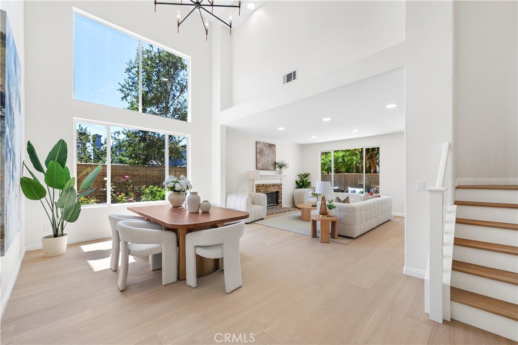 NEWLY REMODELED CORNER UNIT! Nestled in the coveted Lyon Ridge community of Aliso Viejo, this stunning 4-bedroom, 4-bath corner-unit home has been completely transformed with high-end finishes and thoughtful upgrades throughout. Step inside to soaring ceilings, an open floor plan, and a sun-drenched dining and living room that flows seamlessly into a designer kitchen—featuring sleek new cabinets, sparkling countertops, Thor stainless steel appliances, a built-in wine fridge, and a convenient pot filler above the stove—perfect for entertaining or everyday cooking. Rich engineered hardwood floors run throughout the entire home, leading to a spacious downstairs suite with its own ensuite full bath—ideal for guests, a home office, or a future in-law retreat. Another full bath and laundry room complete the first floor. Upstairs, the expansive primary suite offers a peaceful escape, while two additional bedrooms share a beautifully remodeled bath. The home also features a brand new HVAC system for year-round comfort. Located within walking distance to top-rated St. Mary’s private school and award-winning public schools, and just minutes from Whole Foods, Costco, Trader Joe’s, and 99 Ranch Market—this home truly has it all.