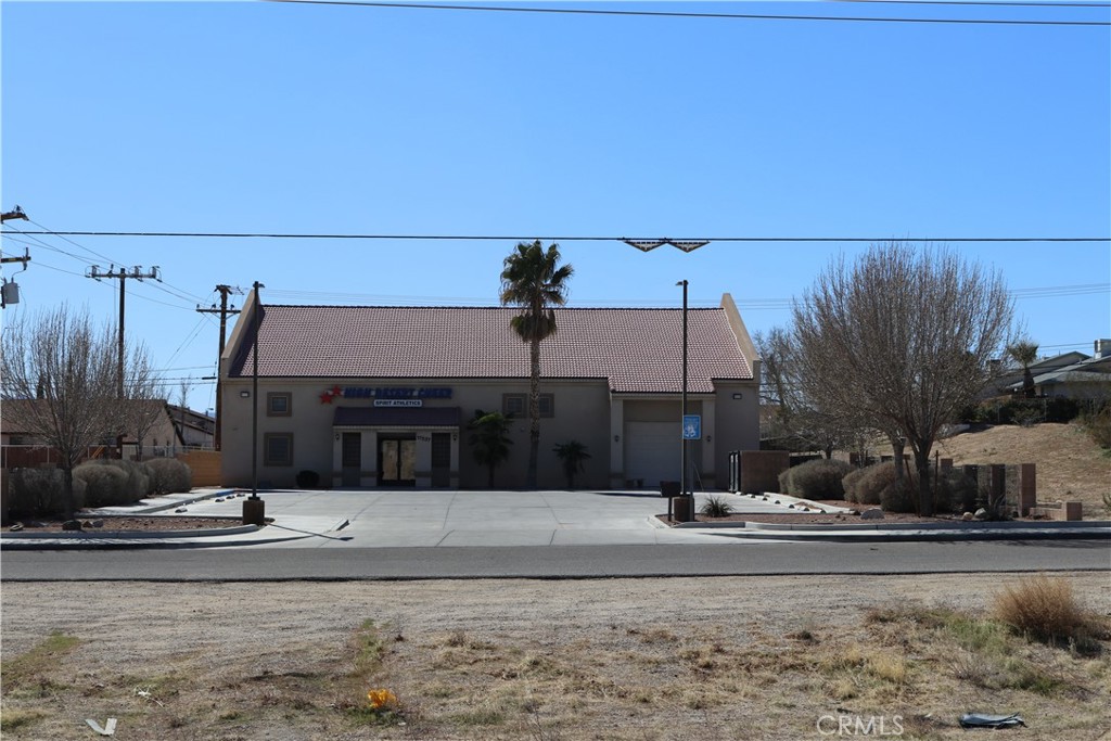 Location Location, located off one of the high deserts busiest highways. Visible to a heavy vehicle count. The building is currently used as a cheerleading gym. 22 foot high ceilings. High bay lighting and exterior parking lot lighting have all been upgraded to LED. The AC/twin pack units run on 3 phase power 110/208 voltage and are located on the roof. Total of 4 restrooms. Lobby restroom is ADA. Stainless filtered drinking fountain. Building well insulated. Building has a lobby area and offices. Building has a roll-up door to parking lot. Building floor is 6 inch 3000psi concrete, stained and sealed. Interior is open concept for the gym floors. Entry is store front doors. Must see this one.