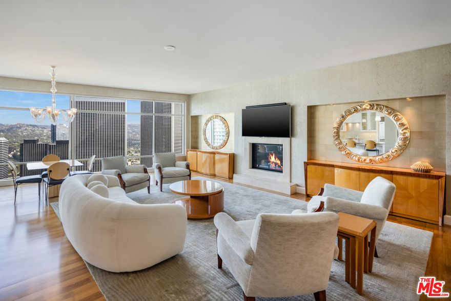 Featuring this stunning 2-bedroom, 3-bath residence at The Century, welcomed by a private double-door entry and showcasing sweeping city-to-mountain vistas through floor-to-ceiling windows. An expansive private terrace seamlessly extends the living spaces outdoors, ideal for entertaining or a quiet retreat. The open-concept design features a sophisticated living room with fireplace, elegant dining area, and a functional kitchen appointed with professional-grade appliances, marble island countertops with an island, and custom cabinetry. A chic powder room is adorned with designer wallpaper, while a bonus space with custom built-ins offers versatility as an office. The primary suite boasts terrace access, a spa-inspired bath with marble finishes, and generous walk-in closets. A spacious laundry room enhances convenience. Renowned architect Robert A.M. Stern designed The Century, one of the West Coast's most prestigious full-service communities, set on 4 acres of landscaped gardens with private pathways, outdoor dining rooms, a wine cellar, screening room, fitness center, resort-style pool with spa and cabanas, valet service, 24-hour guarded gate, and concierge. Minutes from Beverly Hills and the Westside, The Century offers an unmatched lifestyle of elegance and effortless living.