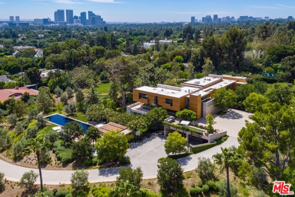 Newly constructed in 2016, the Estate is one of very finest in LA. On 3.25 +/- lush Beverly Hills acres, designed and implemented by world acclaimed Richard Meier & Partners Architects. Timeless yet contemporary, incorporating natural elements such as white oak, stone, and walls of glass create a sense of place. The floor plan offers gallery-like spaces that are intimate & expansive. Each area flows seamlessly to the next, revealing both public and private rooms. 2 staircases and an elevator connect the three levels. Many of the shared spaces occupy the main level including the great room with automated steel doors creating an expansive opening onto the lawn. The lower level houses a professionally equipped 1,148 sf gym and private theater. There are 5 bedrooms situated on the top level. The outdoors are sprawling with Beverly Hills & LA city views. Within the lush landscaping is the entertainment deck featuring an 85-foot, fully tiled infinity pool, pool house & al fresco dining area.