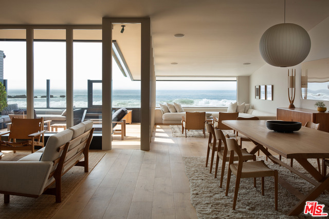 Nestled in the world's most exclusive enclave, Malibu Colony, footsteps from Cross Creek Shopping & legendary Malibu Surf Rider Pier, the Black House is an organic masterpiece that has been renovated to perfection. Striking black cedar shingles adorn a bold, oceanside architectural tour de force, a dramatic blend of sophistication & retro style hearkening back to Malibu's golden age. The interior is a masterful mix of indoor/outdoor living spaces set before the striking beauty of the Pacific Ocean. Walls of glass perfectly frame every sunset, w/boundless views of Malibu's favorite surf spot Old Joe's.The open concept boasts an oceanside lounge, dining space & a ceiling-high brick fireplace, a quintessential piece of Mid-Century design. Walls of glass disappear leading you to an outdoor patio w/direct access to the exclusive private beach. Guests are graciously appointed w/a guest house w/kitchen & bathroom. Bring your board & sandals, & we'll give you the keys to paradise.