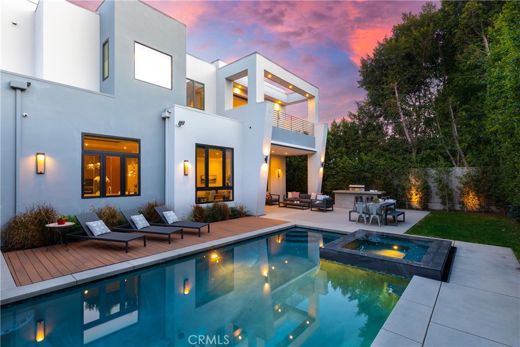 Located in the highly sought after Dixie Canyon School District, this newer construction modern estate features 5 bedrooms, 6 bathrooms and a bonus room. Behind the lush landscaping that helps provide privacy, a pivoting front door invites you into a grand open floor plan that boasts high ceilings. The formal dining area flows seamlessly into the kitchen and family room, the ideal setup for entertaining friends and family alike. The “Italian moda” kitchen showcases a massive island, chef grade Miele appliances and push to open cabinetry. A beautifully designed floating staircase guides you upstairs, where you will find a stunning primary suite that has an open yet cozy feel with a fireplace and private balcony. Unwind after a long day in the freestanding tub and then pamper yourself at the gorgeous vanity adjacent to the spacious walk-in closet. An oversized pocket door opens to reveal a delightful backyard, which plays host to a covered patio, sparkling pool/spa and built-in BBQ. Additional amenities include a laundry room, crestron smart house system and a relaxing front courtyard.