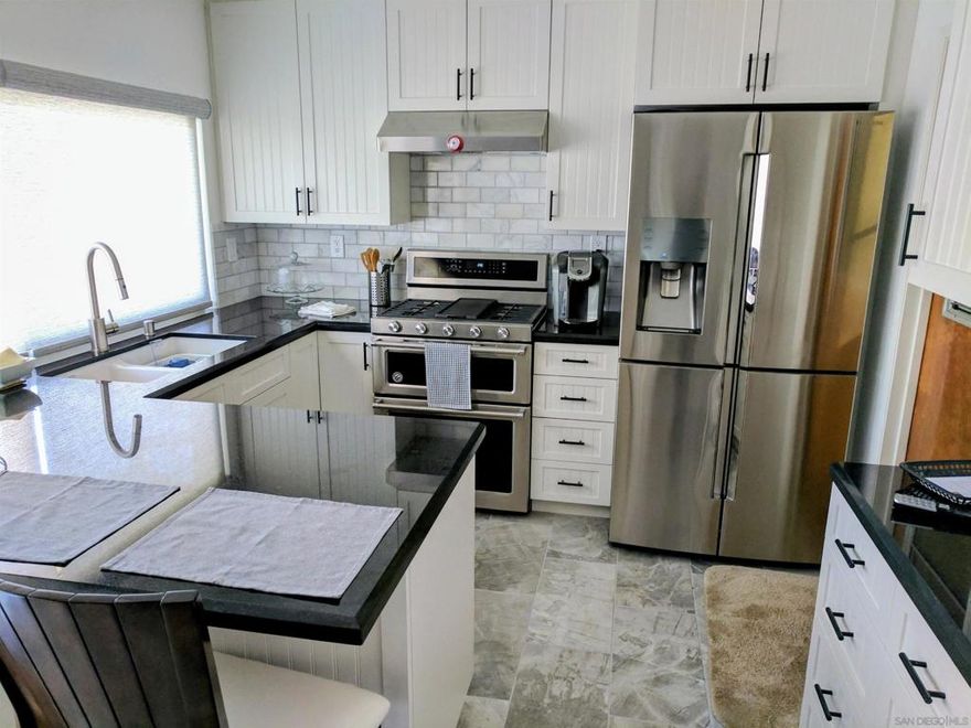 This single-family home has been thoughtfully renovated throughout, boasting a chef-inspired kitchen, brilliant black granite countertops and top-of-the-line appliances. The bathrooms are a spa-like retreat, with marble finishes. This property features a covered patio with a pass through window from the kitchen that makes great for entertaining as it accommodates a 10-seat dining table along with additional bar-style seating for those friendly family parties. This home is designed for both everyday relaxation and grand-scale entertaining for year-round parties and family gatherings. Don't miss this rare opportunity to own this blend of modern luxury and exceptional outdoor living.