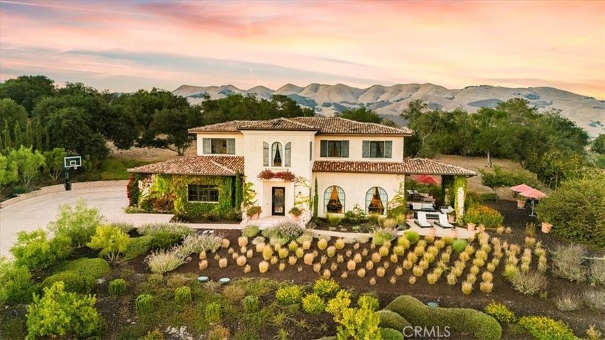 Set near the crest of the prestigious, gated community of Monte Sereno Estates, this refined custom residence showcases sweeping, unobstructed views of the rolling hills and valleys. Completed in 2015, the home was designed to embrace both everyday comfort and effortless entertaining, with seamless indoor-outdoor living at its heart.

Step inside the impressive foyer, where soaring two-story ceilings set the tone for the light-filled, open floor plan. Expansive windows and cathedral ceilings invite natural light throughout, highlighting timeless architectural details like arched passageways, wrought iron accents, exposed wood beams, and rich wood floors.

The gourmet kitchen is a centerpiece, featuring abundant custom cabinetry, extensive granite counters, high-end appliances by SubZero, Wolf, and Miele, plus a spacious pantry designed for the modern chef. The kitchen and living spaces flow to a vast outdoor space with covered patio, perfectly oriented for lounging or entertaining against a backdrop of breathtaking vistas.

Four spacious bedrooms, each with its own en-suite bath, provide comfort and privacy, while a dedicated office offers flexibility for work or study. The primary suite is a true retreat, complete with a spa-inspired bath featuring dual vanities, a large walk-in shower, and a clawfoot soaking tub with views of open space.

Sitting on 1.4 usable acres, the property is enhanced by Magnolias and Ficus trees for added privacy, complemented by vibrant bougainvillea and mature olive trees. Additional features include a newer AC unit, all solid-core doors, and an oversized 3-car garage that is fully finished with epoxy flooring.

Offering more than 3,800 sq. ft. of refined living, this remarkable home blends elegance and warmth in one of the area’s most desirable locations in Monte Sereno. The gated community proudly holds a Firewise certification, reflecting its commitment to wildfire safety through proactive vegetation management and community-wide preparedness. All of this is located just 12 minutes to downtown San Luis Obispo and 7 minutes to the Village of Arroyo Grande.