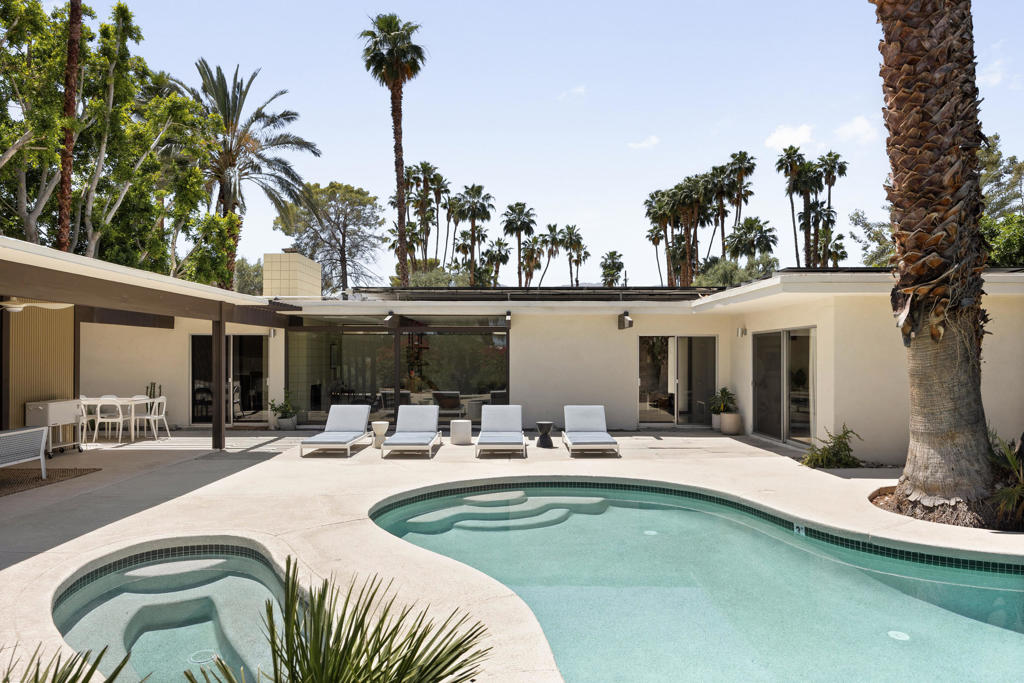 Available for monthly rentals with rates from $6,500/mo to 14,000/mo depending on the season. Originally designed in 1962 by renowned architect Hugh Kaptur, this post-and-beam beauty boasts a timeless appeal. Readers and art enthusiasts will find themselves right at home with books in every corner and popular works of art throughout. Step into a thoughtfully updated kitchen featuring top-of-the-line Bertazonni appliances seamlessly integrated into the original walnut cabinetry, preserving the home's retro allure.Two of the bedrooms open onto private side patios, blending indoor comfort and outdoor serenity. Storage space is generous with spacious closets in each bedroom, and the bathrooms have been tastefully renovated, showcasing contemporary fixtures from Hansgrohe, Dornbracht, and Duravit.The outdoor space is a true entertainer's paradise with plenty of seating, lounge areas, and amenities for everyone, not to mention the lush landscaping throughout the yard that makes you feel like you're in your very own private oasis. Relax under the shaded cabana while watching your favorite movies and shows on the flat-screen TV, or watch right from the pool! Challenge your guests to a game of ping pong and once you've built an appetite, enjoy the ultimate cooking experience on the Mont Alpi BBQ grill. There is even a powder room and separate outdoor shower for you to rinse off after a day of sun-soaked adventures.The gated driveway ensures security and privacy, and electric vehicle drivers will be pleased to find an EV charger on-site for your convenience.This home is centrally located, perfect for taking advantage of the many recreational activities available nearby, from hiking and cycling to horseback riding, golfing, tennis, and beyond.This rental is available for stays of 29 nights or more, providing an extended getaway experience for you and your loved ones.