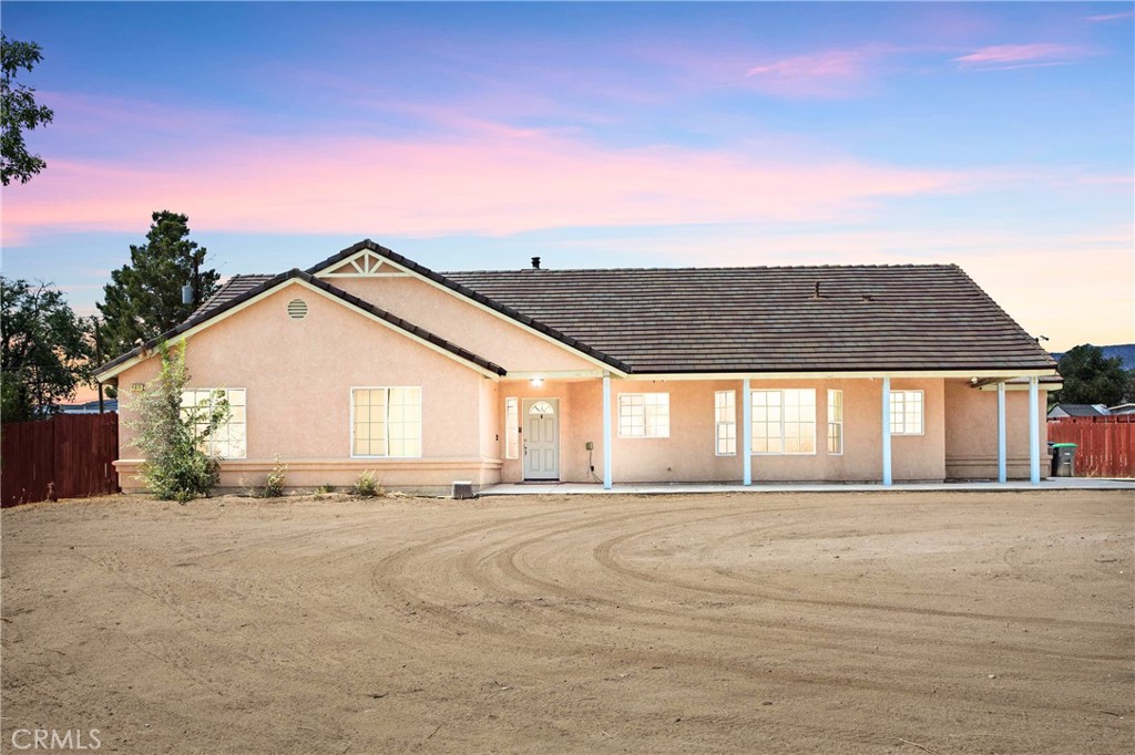Welcome to this charming 3-bedroom, 2-bath home on nearly an acre in peaceful Phelan. Close to Shopping and on a PAVED street. Built in 2008, this well-maintained 1,804 sq ft home features an open-concept layout with tile flooring, a cozy fireplace, and a spacious kitchen perfect for entertaining. The split floor plan offers privacy, while large windows bring in natural light. Enjoy stunning desert views, ample outdoor space, and a fully fenced lot—ideal for animals, toys, or future additions. With an attached 2-car garage and close proximity to schools, this property offers both comfort and convenience in a tranquil, rural setting.