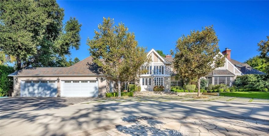 Welcome to this stunning south-of-the-boulevard gated estate, sitting on over one flat acre in the heart of Encino. As the dramatic gates open, you’re greeted by a 30-car cobblestone motor court that sets the tone for this 9,200 sq. ft. residence.

To the south, you’ll find a lit sports court striped for pickleball — the perfect spot for daily matches and weekend fun. The front-facing four-car garage offers abundant storage space, attic access, and is prepped for EV charging.

Step through the grand glass entry doors into an entertainer’s dream home, designed for large gatherings, holidays, and unforgettable parties. The main level offers a huge sunken dining room, a warm and cozy library, a formal living room, and a lively bar room — all opening to the backyard for a seamless indoor-outdoor experience.

The chef’s kitchen boasts soaring ceilings, top-of-the-line stainless steel appliances, two sub-zero refrigerators and freezers paneled to match the kitchen, and a connected family room, perfect for homework, game nights, and casual hangouts. The laundry area leads to a home office, full bathroom, and guest quarters, ideal for long-term visitors or staff accommodations.

The 1,600 sq. ft. primary suite is a retreat in itself, with high-pitched ceilings, a separate sitting room or gym/nursery, a spa-like bathroom with a sunken tub, and a spacious walk-in closet. Just outside the suite is a 1,300-bottle temperature-controlled wine room, accessible from both inside and outside the home.

Upstairs, a dramatic staircase leads to three generous secondary bedrooms, each with an en-suite bath and walk-in closet.

The backyard is an entertainer’s paradise, offering multiple gathering areas for morning coffee or evening cocktails, a covered BBQ and dining space, a sparkling pool, and a separate spa with a dramatic water feature — all surrounded by lush greenery.

This property includes security cameras inside and out as well as security/motion lights all throughout the property. Also included is a Puroserve soft water system.

If you’ve dreamt of living in a true Encino estate, this is your rare opportunity to own one of the neighborhood’s most impressive properties.