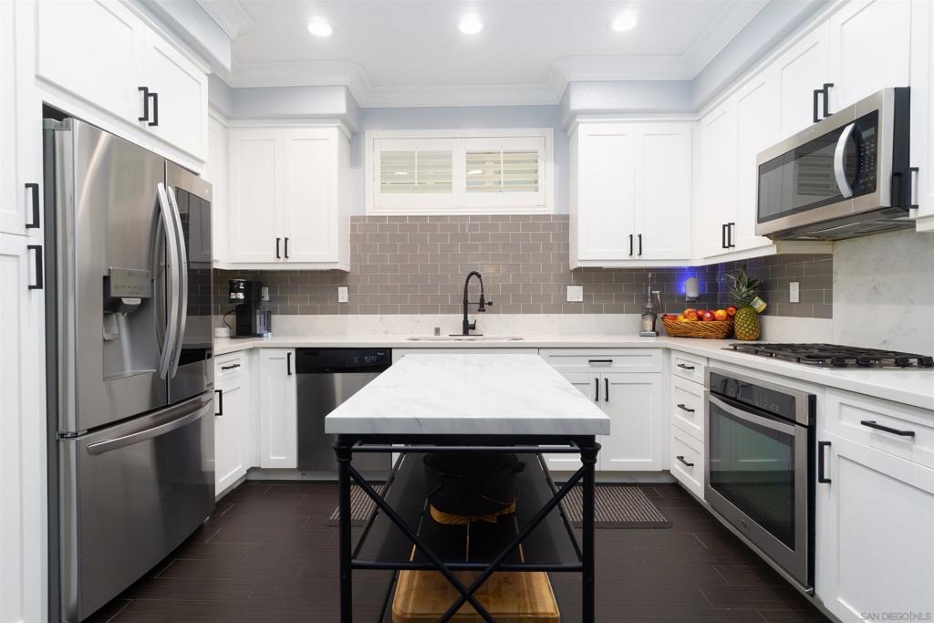 Beautifully updated 3 bedroom 2.5 bath, detached home with option for large 4th bedroom or studio on the 3rd floor. Additionally, the layout offers another option to create new flex space for office or play area on 2nd floor. The home features paid-off solar with EV charging, a modern kitchen with quartz countertops and glass tile backsplash, stainless steel appliances, engineered hardwood flooring, large windows with plantation shutters, dedicated laundry room, newer paint, crown molding throughout, gas fireplace in living room, master suite with walk-in-closet and upgraded dual vanity, private hardscaped patio. Community features pool/spa/gym/bbq areas and more!