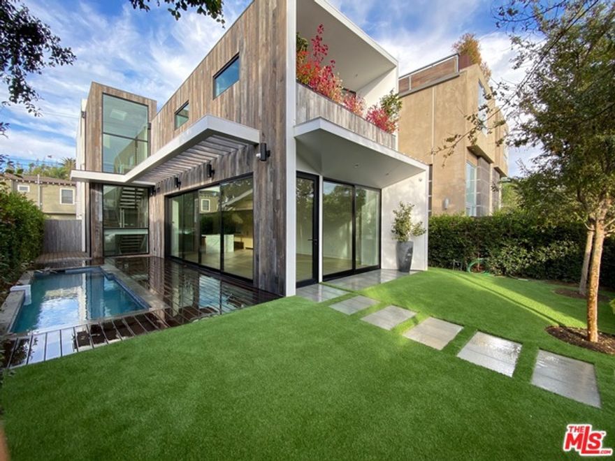 Stunning newer construction Contemporary in prime Venice, steps to Abbot Kinney. This 5 bedroom, 6 bath home exudes impeccable style and quality. The lower level features a state of art theater with 110 inch screen, 500+ bottle wine cellar and game room. The main level presents an open floor plan with wide plank oak floors, gourmet chefs kitchen with beautiful large waterfall island, marble countertops, custom cabinetry, and telescoping glass doors that open to the yard and sparkling pool. 5 bedrooms and bathrooms are on the upper levels. Private yard, perfect for entertaining.