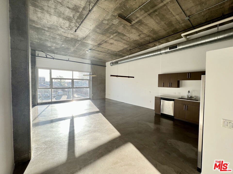 Welcome to Unit #510, a bright and spacious loft offering a flexible open layout, ideal for both living and working. This stunning unit features soaring ceilings, polished concrete floors, and massive floor-to-ceiling windows that flood the space with natural light. The sleek modern kitchen is perfect for entertaining, and the oversized soaking tub offers a relaxing retreat. Additional conveniences include in-unit washer/dryer, gated parking, and 24-hour concierge service.Residents enjoy access to a resort-style rooftop with a pool, fitness center, BBQ area, and panoramic views of the Downtown LA skyline. Located just steps from Little Tokyo and the Arts District's top restaurants, cafes, and galleries this is urban living at its finest.