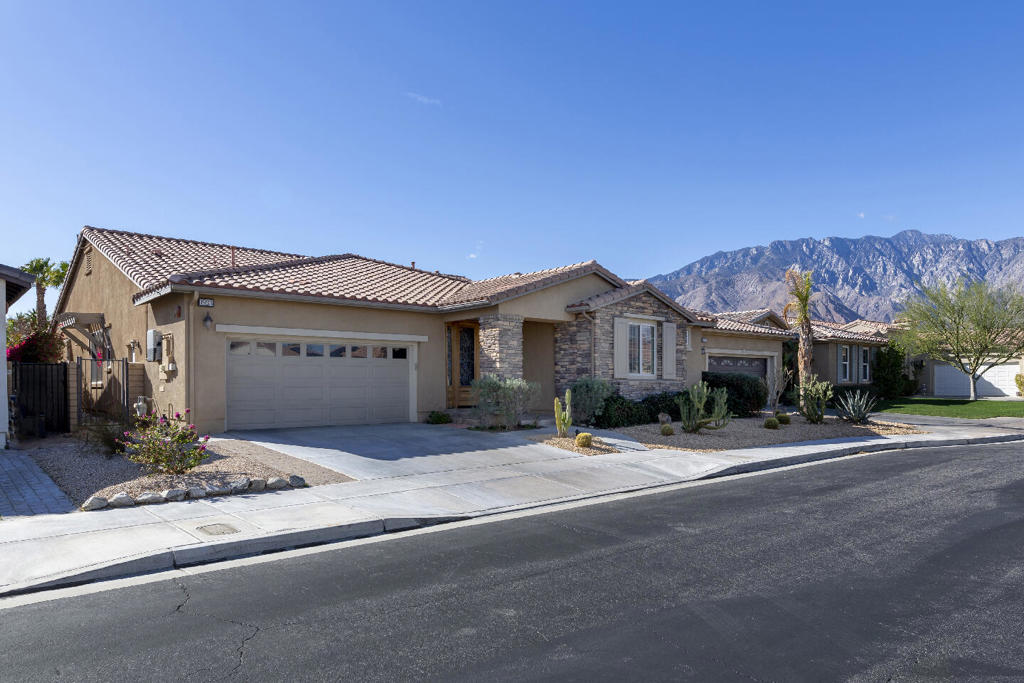 Discover this upgraded Mediterranean-style home in Four Seasons, Palm Springs' premier 55+ community, offering stunning mountain views, owned solar, and an ideal location near the clubhouse. This immaculate 2,825 sqft, 2 bedroom, 3 bath home is perfect for those seeking move-in ready luxury that is both comfortable and provides the benefits of living in an active adult lifestyle neighborhood.Designed for both formal and casual living, the open floor plan features a vaulted dining room and a spacious main living area. French doors open to the covered backyard patio, which boasts mountain views, an artificial lawn, and a BBQ station.The chef's kitchen includes a large prep island, bar area, pantry, and high-end finishes like slab granite counters, wood cabinetry, and a stainless steel appliance package. It is open to the family room, which features a stacked-stone gas fireplace and additional access to the backyard patio.There are two en-suite bedrooms. The rear, primary bedroom has backyard access, a gas fireplace, two walk-in closets, and a spa-style bath with a soaking tub. The front bedroom suite is adjacent to a den/media room, offering the flexibility to be used as a casita-style retreat. The den could potentially be converted into a third bedroom, with the en-suite bath becoming a Jack-and-Jill layout. The home also has built-in speakers, 2 newer HVAC systems that were installed in 2021, a hot water heater installed in 2020, and a water re-circulator.
