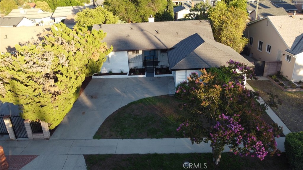 Nestled in a pocket of residential homes, this Sylmar property is move-in ready, including 3 bedrooms and 2 bathrooms. Entering the home you will find a spacious living room with fireplace, with open-concept dining area. The kitchen offers ample cabinet and counter space with additional area for dining. Off the kitchen you will find the laundry room with utility sink, additional storage, and direct access to the side yard. The primary bedroom has direct access to the bathroom and has ample closet space. The additional two rooms are located on the other side of the house where is there is additional storage and full bathroom. The attached garage can be entered from the side of the house. From the living room you can enter the patio leading to a beautiful backyard with BBQ, treelined, fenced backyard with direct access to the alley. The home boasts new paint on the exterior/interior, refinished, original wood flooring, new vinyl flooring in the kitchen, bathrooms, and laundry room, new range, hood vent, washer, dryer, window treatments throughout, and freshly landscaped front and backyard! Great location, close to freeways, area schools, shopping, and restaurants. Make this home, your new home!
