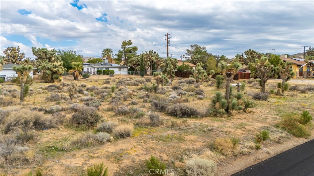 Discover the perfect building lot in Yucca Valley at 7625 Yucca Valley, CA 92284. This 0.43-acre lot features utilities at the street (buyer to verify), gentle natural contouring, and desert character with native Joshua trees and shrubs. Design your custom home, guest quarters, shade patio, and garden retreat in a quiet low-traffic street setting.
You’ll enjoy sweeping mountain views, easy access to grocery stores (Vons, ALDI, Stater Bros.), local cafés, and community charm along 29 Palms Hwy. Schools serving the area include Yucca Valley Elementary and Yucca Valley High, part of the Morongo Unified School District. Nearby attractions include Desert Christ Park, the Hi-Desert Nature Museum, Black Rock Canyon trails, and all the beauty of Joshua Tree National Park right in your backyard.
Embrace desert living, starlit nights, and the freedom to build your vision. Bring your architect and builder—this lot is ready to shine.