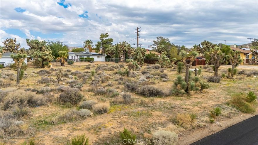Discover the perfect building lot in Yucca Valley at 7625 Yucca Valley, CA 92284. This 0.43-acre lot features utilities at the street (buyer to verify), gentle natural contouring, and desert character with native Joshua trees and shrubs. Design your custom home, guest quarters, shade patio, and garden retreat in a quiet low-traffic street setting.

You’ll enjoy sweeping mountain views, easy access to grocery stores (Vons, ALDI, Stater Bros.), local cafés, and community charm along 29 Palms Hwy. Schools serving the area include Yucca Valley Elementary and Yucca Valley High, part of the Morongo Unified School District. Nearby attractions include Desert Christ Park, the Hi-Desert Nature Museum, Black Rock Canyon trails, and all the beauty of Joshua Tree National Park right in your backyard.

Embrace desert living, starlit nights, and the freedom to build your vision. Bring your architect and builder—this lot is ready to shine.