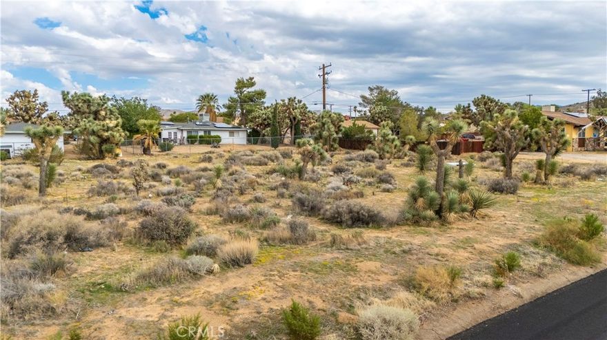 Discover the perfect building lot in Yucca Valley at 7625 Yucca Valley, CA 92284. This 0.43-acre lot features utilities at the street (buyer to verify), gentle natural contouring, and desert character with native Joshua trees and shrubs. Design your custom home, guest quarters, shade patio, and garden retreat in a quiet low-traffic street setting.
You’ll enjoy sweeping mountain views, easy access to grocery stores (Vons, ALDI, Stater Bros.), local cafés, and community charm along 29 Palms Hwy. Schools serving the area include Yucca Valley Elementary and Yucca Valley High, part of the Morongo Unified School District. Nearby attractions include Desert Christ Park, the Hi-Desert Nature Museum, Black Rock Canyon trails, and all the beauty of Joshua Tree National Park right in your backyard.
Embrace desert living, starlit nights, and the freedom to build your vision. Bring your architect and builder—this lot is ready to shine.