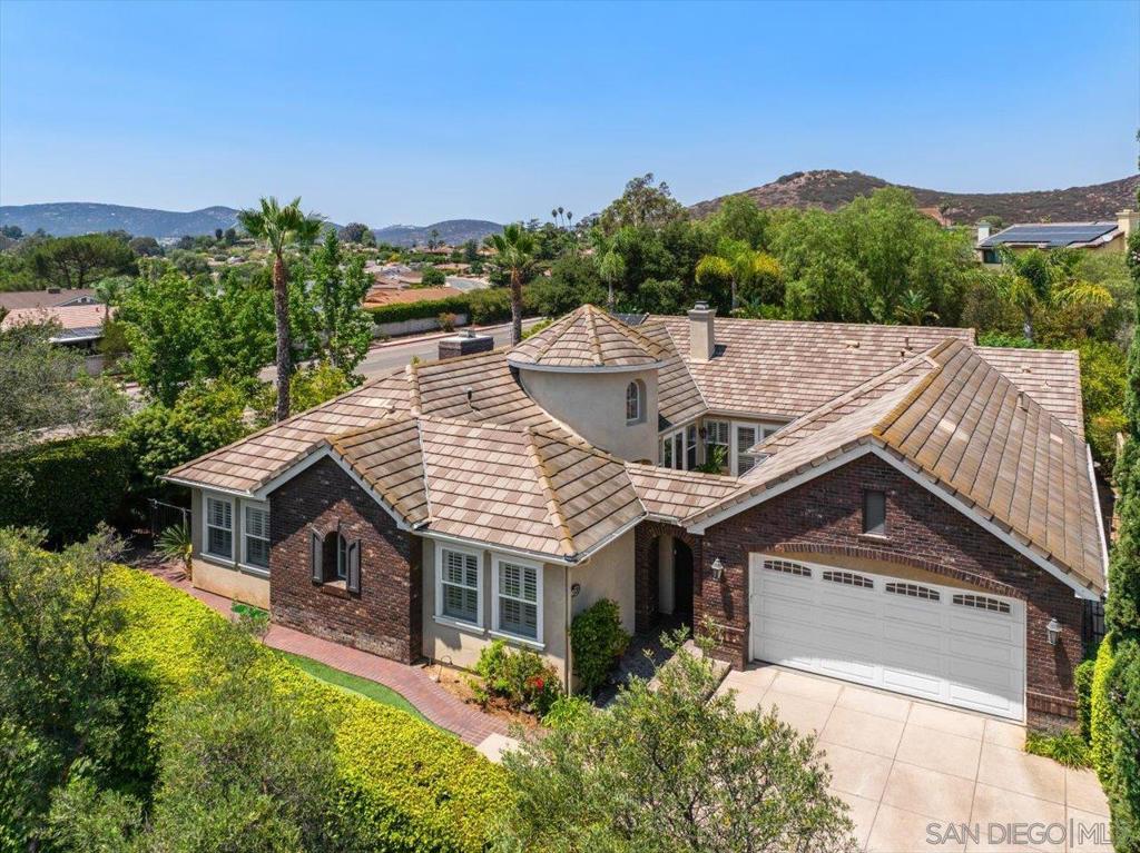 Prestigious Vezelay estate in Rancho Bernardo. Nestled in the exclusive gated community of Vezelay, this French country–inspired single-story home offers 4 bedrooms, 3.5 baths, and timeless elegance. Set back from the street, a long, graceful driveway framed by a stately privacy hedge leads to a charming brick-accented entrance, complete with a beautiful wood privacy gate opening to a serene courtyard. Inside, soaring 10-foot ceilings, recessed lighting, and rich walnut hardwood floors create an inviting sense of space. Multiple French doors connect the interior to the central courtyard and to the backyard retreat, where a covered patio overlooks a sparkling tiled pool with jetted spa. The chef’s kitchen is a culinary masterpiece, featuring stainless steel GE Monogram appliances—including a six-burner gas cooktop, double ovens, microwave/convection oven, warming drawer, refrigerator, and wine fridge—alongside dual KitchenAid dishwashers, solid-surface countertops, a butler’s pantry, and a spacious walk-in pantry. The adjacent family room offers an open, welcoming atmosphere with a striking brick fireplace and direct access to the covered patio. The formal living room boasts a marble fireplace and custom built-ins for books, décor, and media. (See Supplement) The luxurious primary suite includes an exquisite custom-organized walk-in closet, dual marble-topped vanities, a soaking tub, and a walk-in shower with twin rain shower heads and frameless glass enclosure. Two secondary bedrooms share a Jack-and-Jill bath (one with a Murphy bed), while a third enjoys a private en-suite bathroom. A tandem three-car garage with built-in cabinetry adds functionality, with one bay currently converted to a storage area. The entertainer’s backyard is complete with a built-in barbecue, outdoor fireplace, and a four-hole putting green—perfect for year-round enjoyment.