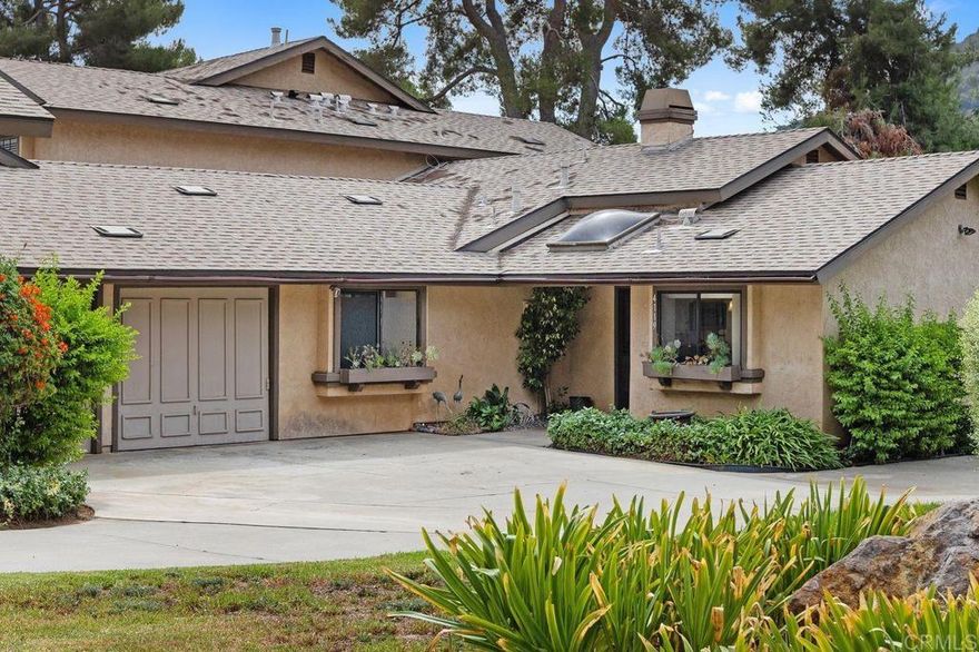 Welcome to this charming single-story 2-bed, 2-bath home with peaceful golf course views, tucked away in the popular Pala Mesa Villas community. Set along the second hole, this rarely available Augusta model offers a wonderful mix of privacy, comfort, and beautiful surroundings. The home is situated at the end of a long driveway, and with no neighbors above or below you, it truly feels like a detached home. As you enter the home, you are greeted by an abundance of natural light and breathtaking views of the Pala Mesa golf course. Other features of the home include newly installed LVP flooring and baseboards, a cozy fireplace with stacked stone and custom mantle, ceiling fans in the living room and bedrooms, and A/C. The spacious primary bedroom also enjoys golf course views and features a large walk-in closet and an en-suite bathroom which has been completely remodeled to include a custom vanity with dual sinks, a walk-in shower, and a separate walk-in jetted tub. The guest bedroom features an en-suite, remodeled, wheelchair accessible bathroom. Enjoy the convenience of an attached 1.5-car garage, large enough for a vehicle and a golf cart, plus a private driveway with parking for multiple cars and an additional guest space adjacent to the home. Relax on the back patio and enjoy the golf course views and fabulous breezes while enjoying your morning coffee or afternoon tea. The community features 2 pools & hot tubs and the HOA fee covers water, sewer, exterior bldg. maintenance, roof, and common area landscaping. With quick access to the 15 freeway, you’re just a short drive to wineries, restaurants, and shops in both Fallbrook and Temecula. Whether you’re searching for a primary residence or a relaxing second home, this tranquil golf course retreat delivers the perfect blend of comfort, convenience, and lifestyle.