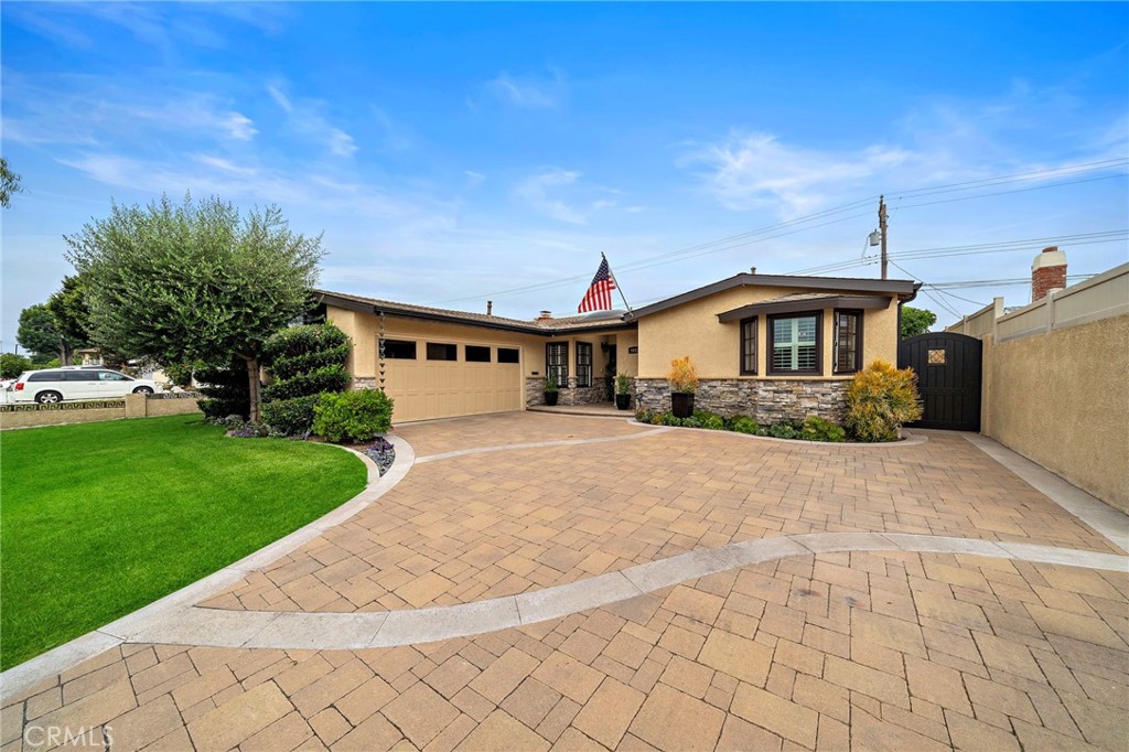 Words can only begin to describe the beauty and impeccable craftsmanship that went into the expansion and transformation of this sprawling 1,855 SF single-level masterpiece, where every detail has been meticulously crafted to create a sanctuary of comfort and sophistication. Located in one of Fountain Valley’s premier neighborhoods with top-ranked schools and just 4 miles to the beach, this exceptional residence beckons you with its captivating curb appeal, including pristine landscaping, stacked-stone siding, and an interlocking paver driveway. Step through custom double entry doors to a light-filled open design blending the elegant living room, banquet-size dining room, gourmet kitchen, and breakfast room, showcasing its many upgrades and gorgeous architectural features, including rich hardwood floors, dual-pane French windows, multiple bay windows, plantation shutters, recessed lighting, surround sound, crown molding, wainscoting, solid two-panel doors, and central A/C. The impressive remodeled chef’s dream kitchen boasts granite counters, a center island with double-sided bar seating, bay window above deep stainless sink, white shaker self-closing cabinetry with pull-outs, undercabinet lighting, glass display panels, and stainless appliances including Bosch dishwasher and Dacor gas range with electric oven. The living room features a stacked-stone fireplace, custom built-ins, and bayed extension with sliders to a stunning resort-style backyard oasis that will take your breath away with its bubbling spa, stacked-stone planters & accents, stunning paver and artificial turf decking, tiled outdoor kitchen/BBQ under a Hawaiian thatched palapa with bar seating, fridge, buffet counter, sink, and wine fridge. Relax by the fireplace under the patio cover, enjoy the fountain, or practice on the putting green. Paradise found in this outdoor living & entertaining space. Both bathrooms are luxuriously remodeled with dual sinks, quartz counters, designer tile, frameless glass, and chic fixtures -- the primary with giant walk-in shower and the hall bath with oversized soaking tub/shower combo. The primary suite offers a huge walk-in closet with custom organizers; secondary bedrooms have wood-framed mirrored closets, and one bedroom has a Murphy bed. Additional features include: copper plumbing, underground utilities, tankless water heater, outdoor shower, and RV-potential side yard. This magnificent home is one not to be missed!