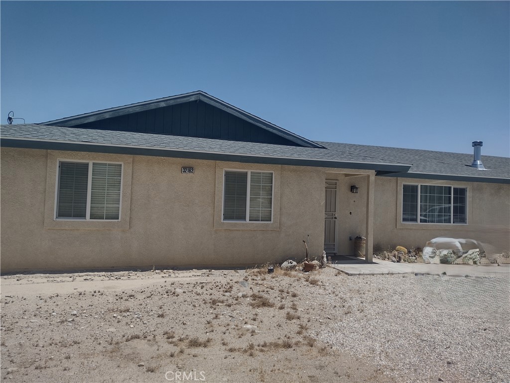 *Updated photos to follow soon* Located in the very desirable Gem Tract of Lucerne Valley, this 3 bedroom 2 bath home is waiting for you! Enter through the front door to a large family/living room equipped with an upgraded pellet stove to keep you cozy. Large windows take in the expansive views of the Big Bear Mountains to the South. The dining area features a sliding glass door that leads to a small outdoor patio/area, and even more views - of the valley below. The kitchen includes dishwasher, fridge, as well as a separate laundry room with storage and washer and dryer (included!). Walk down the hallway to access additional storage space as well as the bedrooms, all with large mirrored closets (furniture is negotiable!). The Primary bedroom shares no walls with the other bedrooms, and has its own bathroom for added privacy. A paved driveway leads to the attached two car garage, which is fully finished on the inside. The garage along with the 3 storage containers in the backyard (included!) give ample storage. The property is partially fenced, separating the back yard from the front. Central Air will keep you cool in the summer, while paved road access will make commuting a breeze. Serviced by a Water Company, private septic, and propane for all your needs. Home is also equipped with a security system and fire sprinklers for peace of mind.