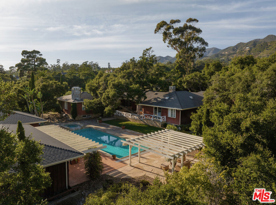 Located in the heart of Montecito's acclaimed Golden Quadrangle and mere footsteps from the Upper Village, this serene and spacious haven is an invitation to breathe easy and discover your best life in quintessential Montecito.From the tranquility of this +/- 1.3-acre oasis, wake up to the daily inspiration of mountain views or take an afternoon dip in the sparkling pool. A short stroll will take you to Pierre Lafond Market or The Pharmacy for breakfast, and on more adventurous days, a hike along the nearby Hot Springs Trail will invigorate your mind and body. And that's if you decide to leave the house!Framed by sprawling grandfather oaks and enchanting garden spaces, the peaceful property offers an ideal getaway. The multi-structure compound features 2 gated entries, a 4 bed/4.5 bath main residence with an attached 3-car garage, a charming detached guest cottage, and a pool house all pleasantly situated around a central courtyard with a pool, spa, and outdoor patio areas. A secondary 2-car garage offers additional space for vehicles, storage, or even a home gym.The single-level main residence features vaulted ceilings with open wood beams, cozy cobblestone fireplaces, beautiful wood floors, and large windows which welcome abundant natural light. A central south-facing corridor with multiple French doors beckons enjoyment of the outdoor areas. The primary bedroom commands its own private quadrant of the main residence and boasts a fireplace, high ceilings, a luxurious bathroom suite, and ample closet space. Three additional guest bedrooms plus an office ensure comfortable accommodations for family or guests in the main residence.The generous and fully usable flat parcel means you can enjoy the serene natural surroundings as they are, or let your imagination dream up future expansion possibilities. San Ysidro Ranch, Montecito Union School, and Rosewood Miramar Beach are just a few of the desirable amenities all located in near-perfect proximity to this beautiful estate. No matter how you envision yourself enjoying it, this alluring enclave embodies the very best of Montecito living and a rare opportunity to make your dream life a reality.