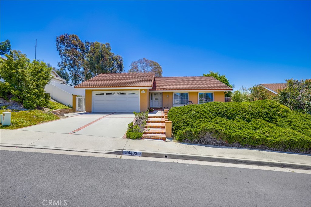 Upgraded desirable single level beauty, ideal central Mission Viejo location close to local schools, shopping, dining, local family friendly parks, and easy 5 frwy access. The manicured, water conscious landscaping, brick lined walkways, and the classic Mission Viejo Co architecture create a welcoming first impression. Step through the beautiful front door entry with leaded glass details and soak in the gorgeous interior. Vaulted, open beam ceilings, sleek luxury vinyl plank flooring, and a well-designed floor plan create a superb living environment. The living area is the perfect gathering space around the handsome fireplace with large wrap-around windows and direct access through the sliding doors to the backyard and patio providing an ideal indoor-outdoor living space for relaxing with friends and family. The family kitchen has been beautifully updated with rich warm cabinetry, glass door cupboards, Granite countertops, a large garden window, perfect for a home herb garden, providing soothing backyard views, and a sunny breakfast nook with sliders opening to the patio creating an excellent setting for entertaining. The primary bedroom suite is a peaceful retreat with mirrored closet doors, vaulted ceilings, and a private bath with upgraded Granite topped vanity, upgraded faucet and fixtures, and large step-in shower. A full guest bathroom and two guest bedrooms, including a guest bedroom with double door entry which is ideally suited for an executive home office or media room, completes this desirable floor plan. The backyard is a private tranquil oasis with a large, covered patio, water conscious landscaping, charming white picket fence, soothing views, and a prized garden/work shed wired with electricity, a perfect setting for relaxing in the amazing OC weather and BBQing with loved ones. The direct access 2 car garage has built-in storage. Close to shopping, dining, entertainment, several local schools including Mission Viejo High and La Paz Intermediate and Linda Vista Elementary, and just minutes from local beaches. No Mello Roos!