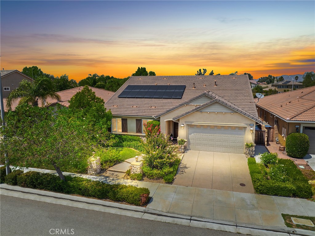 Discover this stunning formal model home nestled in the prestigious Heritage Lakes community of Menifee, where luxury meets comfort in every detail. This exquisite single-story residence boasts 3 spacious bedrooms plus a versatile den, thoughtfully designed with over 2,300 square feet of meticulously planned living space. The intelligent floor plan strategically positions the secondary bedrooms and master suite at opposite ends of the home, ensuring optimal privacy and tranquility for all occupants. The impressive 3-car tandem garage provides abundant storage and parking, while the interior showcases elegant engineered hardwood floors flowing seamlessly throughout the common areas, perfectly complemented by brand new plush carpeting in all bedrooms. The heart of the home features a magnificent family room anchored by a stunning fireplace flanked by beautiful built-in bookshelves on both sides, creating an atmosphere of sophistication and warmth. Premium plantation shutters grace every window, offering both style and privacy, while integrated speakers throughout the home provide the perfect soundtrack for daily living and entertaining. The exterior commands attention with beautiful curb appeal that reflects the pride of ownership evident in every corner of this immaculate property. Step into the backyard oasis where beautifully landscaped grounds create a peaceful retreat perfect for relaxation and outdoor gatherings. Comfort is assured year-round with a brand new compressor and evaporator unit featuring dual zone HVAC control, allowing personalized climate management throughout the home, while leased solar panels provide energy-efficient living and reduced utility costs. This exceptional property represents the perfect blend of elegance, functionality, and modern convenience in one of Menifee's most sought-after neighborhoods, where residents enjoy exclusive access to Heritage Lakes' outstanding amenities including a clubhouse, two Jr. Olympic-sized swimming pools, a splash park, a wading pool, and multiple tot-lots for family recreation. The community also provides paddleboats for lake access, catch-and-release fishing opportunities, fitness trails equipped with exercise stations, and engaging community events that foster a vibrant neighborhood lifestyle.